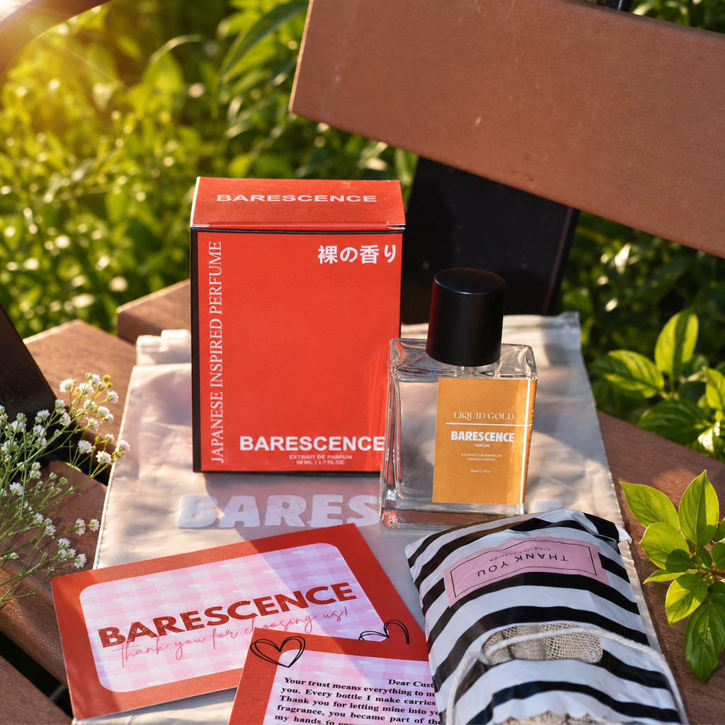 Barescence perfume bottle and packaging on a wooden surface with greenery in the background