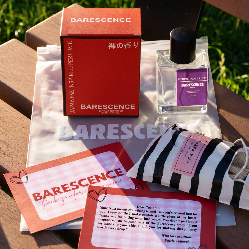 Barescence perfume set with packaging and cards on a wooden surface outdoors.