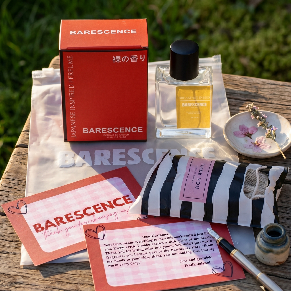Barescence perfume set with packaging and cards on a wooden surface outdoors.
